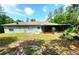 Home exterior with screened-in patio, set amidst a green backyard and mature trees at 1561 Copperfield Ave, Deltona, FL 32738