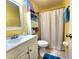 Bathroom with tiled floors, large mirror and shower with curtain at 1561 Copperfield Ave, Deltona, FL 32738