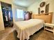 Comfortable bedroom with a window, closet, wooden headboard and a small white table at 1561 Copperfield Ave, Deltona, FL 32738