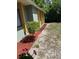 A mulch bed with newly-planted small tree to the side of the house at 1561 Copperfield Ave, Deltona, FL 32738