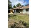 Charming single-story home with well-maintained lawn and vibrant, painted yellow garage door at 1561 Copperfield Ave, Deltona, FL 32738