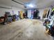 Spacious garage offering ample storage and parking, with various tools and equipment neatly arranged along the walls at 1561 Copperfield Ave, Deltona, FL 32738
