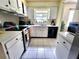 Bright kitchen with white cabinets, tile floor and stainless steel oven range at 1561 Copperfield Ave, Deltona, FL 32738