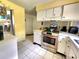 Kitchen with stainless steel oven range, white cabinets, and tiled floor at 1561 Copperfield Ave, Deltona, FL 32738