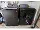 Laundry room with gray GE washer and dryer at 1561 Copperfield Ave, Deltona, FL 32738