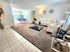 Open floor plan with bright dining area and dark wood accent table with decor in the living room at 1561 Copperfield Ave, Deltona, FL 32738