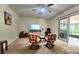Carpeted living room with chairs and view to screened patio at 1561 Copperfield Ave, Deltona, FL 32738