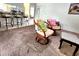 Carpeted living room with chairs and view of kitchen bar with seating at 1561 Copperfield Ave, Deltona, FL 32738