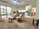Spacious living room with carpet, chairs, and kitchen view with breakfast bar at 1561 Copperfield Ave, Deltona, FL 32738