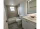 Bathroom with a shower-tub combo, neutral tile, modern vanity, and illuminated mirror at 1810 Western Rd, South Daytona, FL 32119