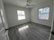 Bright bedroom featuring wood-look floors, neutral finishes, and a window with natural light at 1810 Western Rd, South Daytona, FL 32119
