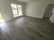 Bedroom featuring wood-look floors, window with blinds, white walls, and neutral finishes at 1810 Western Rd, South Daytona, FL 32119