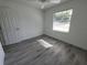 Bedroom with wood-look flooring and bright, natural light at 1810 Western Rd, South Daytona, FL 32119