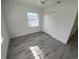 Light and airy bedroom features wood-look flooring and a ceiling fan at 1810 Western Rd, South Daytona, FL 32119