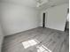 Bedroom featuring wood-look floors, ceiling fan, white walls, and neutral finishes at 1810 Western Rd, South Daytona, FL 32119