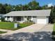 Well-maintained single-story home with attached garage, concrete driveway, and landscaped front yard at 1810 Western Rd, South Daytona, FL 32119