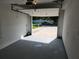 Spacious garage with painted floor and a view to the driveway at 1810 Western Rd, South Daytona, FL 32119