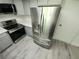 Modern kitchen featuring stainless steel refrigerator, stove, and sleek grey cabinets, perfect for cooking at 1810 Western Rd, South Daytona, FL 32119