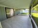 Enjoy the outdoors on this screened lanai featuring tiled floors and views of the surrounding yard at 1810 Western Rd, South Daytona, FL 32119