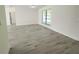 Bright living room featuring durable floors, fresh paint, and a large window allowing natural light at 1810 Western Rd, South Daytona, FL 32119