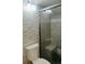 Modern bathroom features a glass-enclosed shower with built-in seating and decorative tile at 1909 S Atlantic Ave # 405/406, Daytona Beach Shores, FL 32118