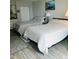 Bright bedroom featuring two beds, wood-look floors, and a calming color palette at 1909 S Atlantic Ave # 405/406, Daytona Beach Shores, FL 32118
