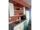 Compact kitchenette features white cabinets, granite countertops, and modern appliances at 1909 S Atlantic Ave # 405/406, Daytona Beach Shores, FL 32118