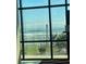 Breathtaking ocean view through large windows, complemented by lush landscaping at 1909 S Atlantic Ave # 405/406, Daytona Beach Shores, FL 32118