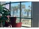 Picturesque ocean view framed by palm trees and comfortable seating area at 1909 S Atlantic Ave # 405/406, Daytona Beach Shores, FL 32118