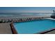 Expansive pool deck with ocean views and comfortable seating at 1909 S Atlantic Ave # 405/406, Daytona Beach Shores, FL 32118