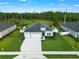Stunning aerial view of a well-maintained home with a large driveway and beautiful backyard landscaping at 2137 Raglan Cir, Ormond Beach, FL 32174