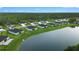 Impressive aerial view of homes next to a lake featuring manicured lawns and mature landscaping at 2137 Raglan Cir, Ormond Beach, FL 32174
