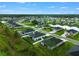 Gorgeous aerial view of neighborhood homes surrounding a scenic pond and mature trees at 2137 Raglan Cir, Ormond Beach, FL 32174