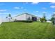Spacious backyard features a pristine lawn, complemented by mature trees and a privacy fence at 2137 Raglan Cir, Ormond Beach, FL 32174