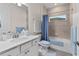 Bright bathroom featuring a white vanity, a bathtub with shower, and soft blue accents at 2137 Raglan Cir, Ormond Beach, FL 32174