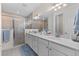 Luxurious bathroom with dual sinks, ample counter space, and a seamless glass shower at 2137 Raglan Cir, Ormond Beach, FL 32174