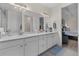 Beautiful bathroom with double sinks, quartz countertop, and a view into the main bedroom at 2137 Raglan Cir, Ormond Beach, FL 32174