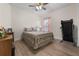 Calm bedroom with a floral quilt, wood-look floors, and a window with pink curtains at 2137 Raglan Cir, Ormond Beach, FL 32174