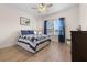 Comfortable bedroom with blue accents, wood floors, and a bright window with blue curtains at 2137 Raglan Cir, Ormond Beach, FL 32174