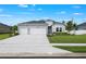 Charming one-story home with a three-car garage, manicured lawn, and elegant landscaping at 2137 Raglan Cir, Ormond Beach, FL 32174