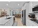 Well-lit kitchen with stainless steel appliances, white cabinetry, and a convenient center island at 2137 Raglan Cir, Ormond Beach, FL 32174