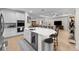 Modern kitchen featuring white cabinets, a center island, and seamless flow to living spaces at 2137 Raglan Cir, Ormond Beach, FL 32174