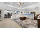 Spacious living room featuring a large sectional, stylish rug, and wood-look tile flooring at 2137 Raglan Cir, Ormond Beach, FL 32174