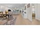 Open-concept living and dining area showcasing modern furnishings and wood-look tile floors at 2137 Raglan Cir, Ormond Beach, FL 32174