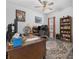 Inviting home office featuring a large wooden desk, ceiling fan, and ample natural light at 2137 Raglan Cir, Ormond Beach, FL 32174