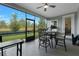 Enjoy outdoor living on this screened patio with a ceiling fan and views of the lush backyard at 2137 Raglan Cir, Ormond Beach, FL 32174