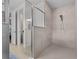Modern walk-in shower with tile surround and glass door at 2137 Raglan Cir, Ormond Beach, FL 32174