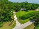 Expansive property featuring a long driveway, lush lawn, mature trees, and a home in a private, serene setting at 21375 Nw 150Th Avenue Rd, Micanopy, FL 32667