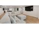 Spacious basement living area with a comfortable sofa, tv, and light wood-look floors at 21375 Nw 150Th Avenue Rd, Micanopy, FL 32667