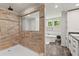 Modern bathroom showcasing a glass-enclosed shower with tan tiles, a soaking tub, and stylish fixtures at 21375 Nw 150Th Avenue Rd, Micanopy, FL 32667